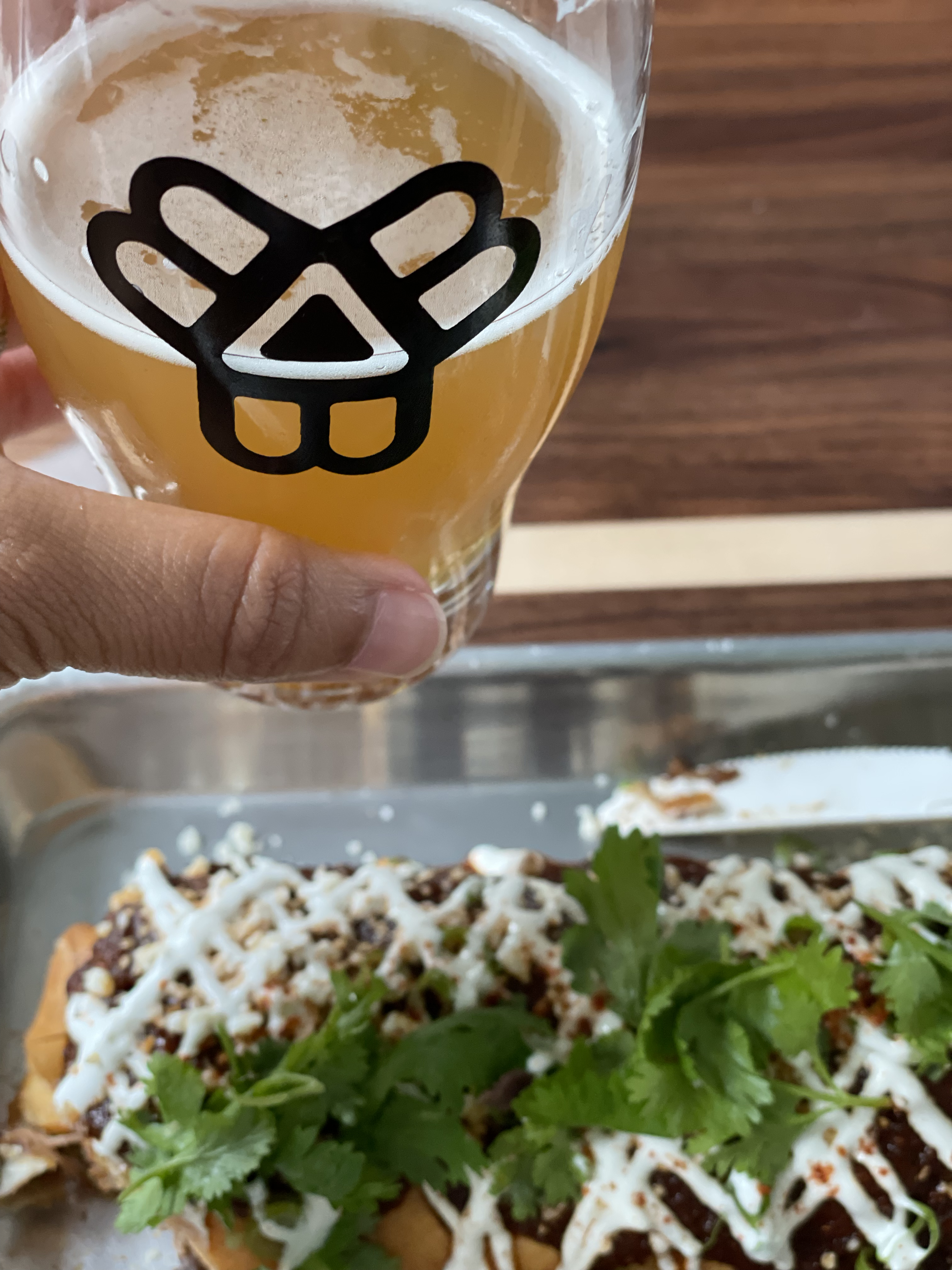 person holding a beer over a chimichanga